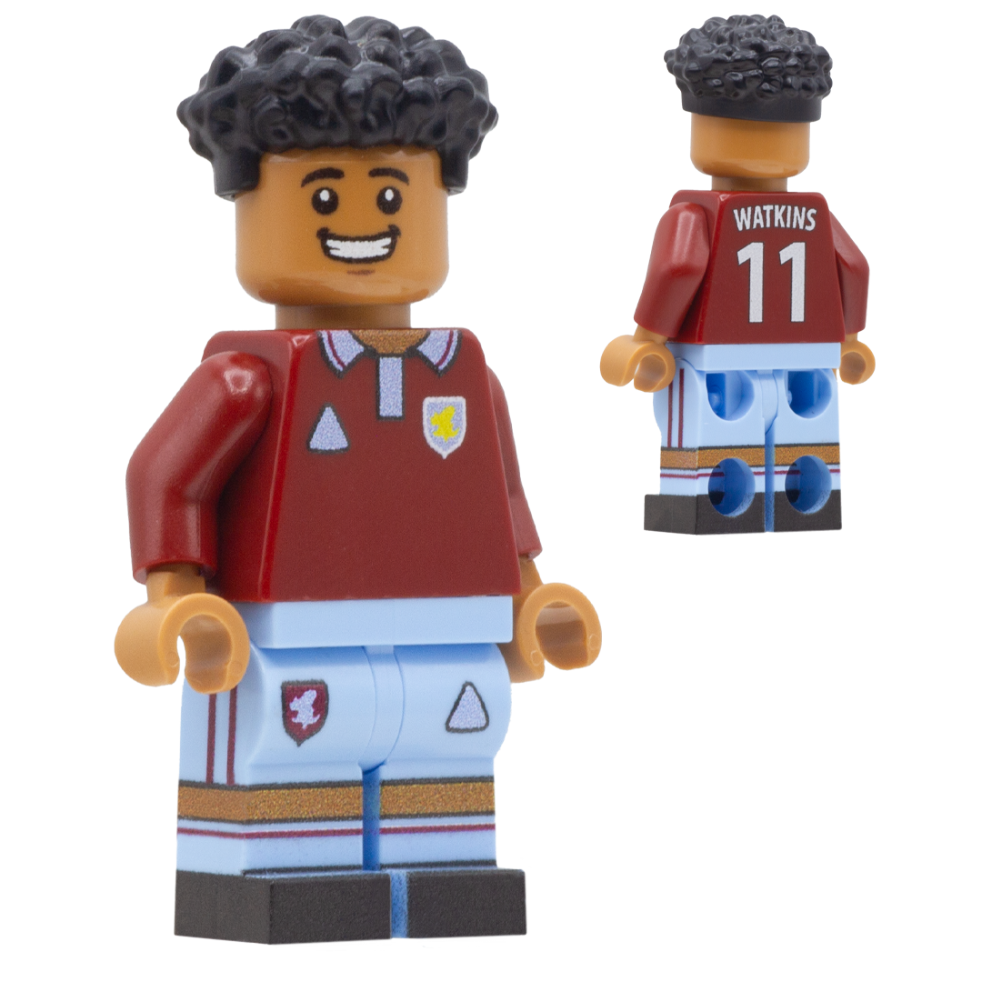 A LEGO-style football minifigure depicting Ollie Watkins. The figure wears a dark red jersey with a white collar, light blue shorts, and black curly hair.