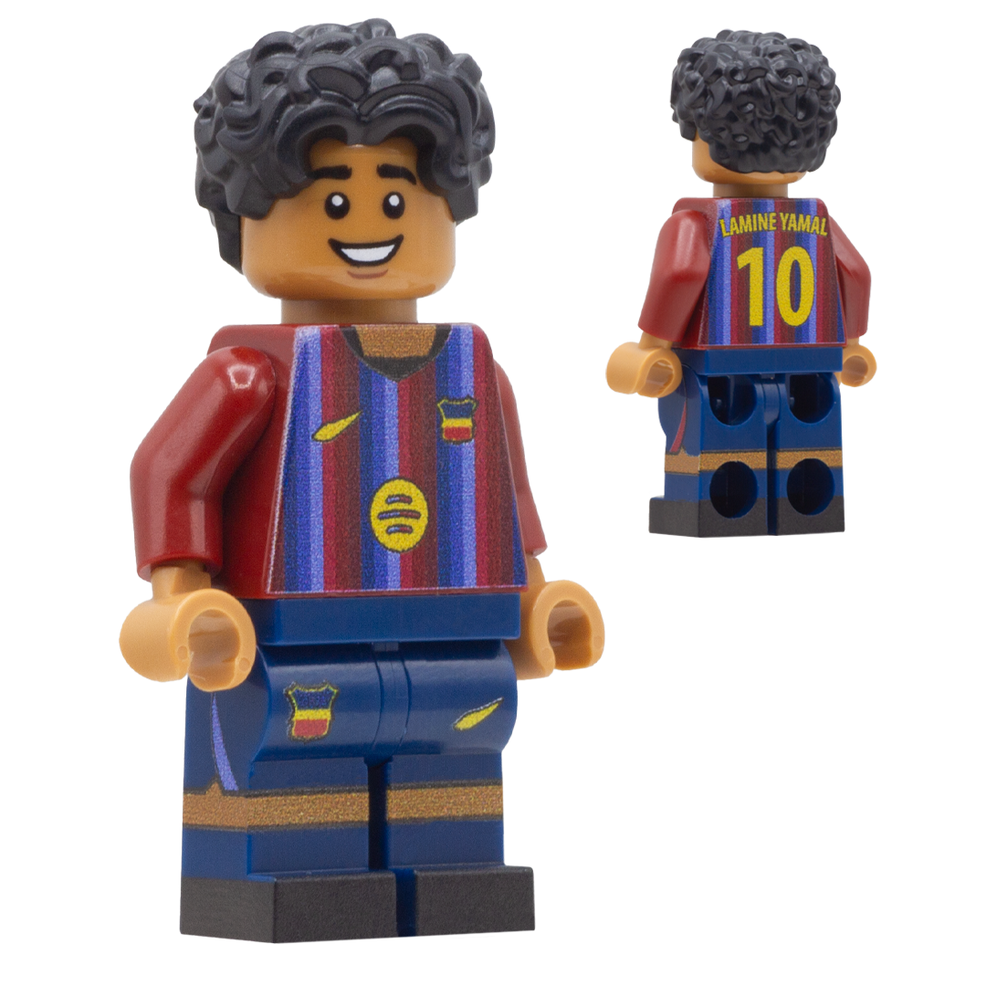 A LEGO-style soccer minifigure of Barcelona FC footballer Lamine Yamal. The figure has curly black hair, a smiling face, a claret red and blue striped jersey with yellow accents, and blue shorts with gold stripes.