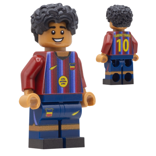 A LEGO-style soccer minifigure of Barcelona FC footballer Lamine Yamal. The figure has curly black hair, a smiling face, a claret red and blue striped jersey with yellow accents, and blue shorts with gold stripes.