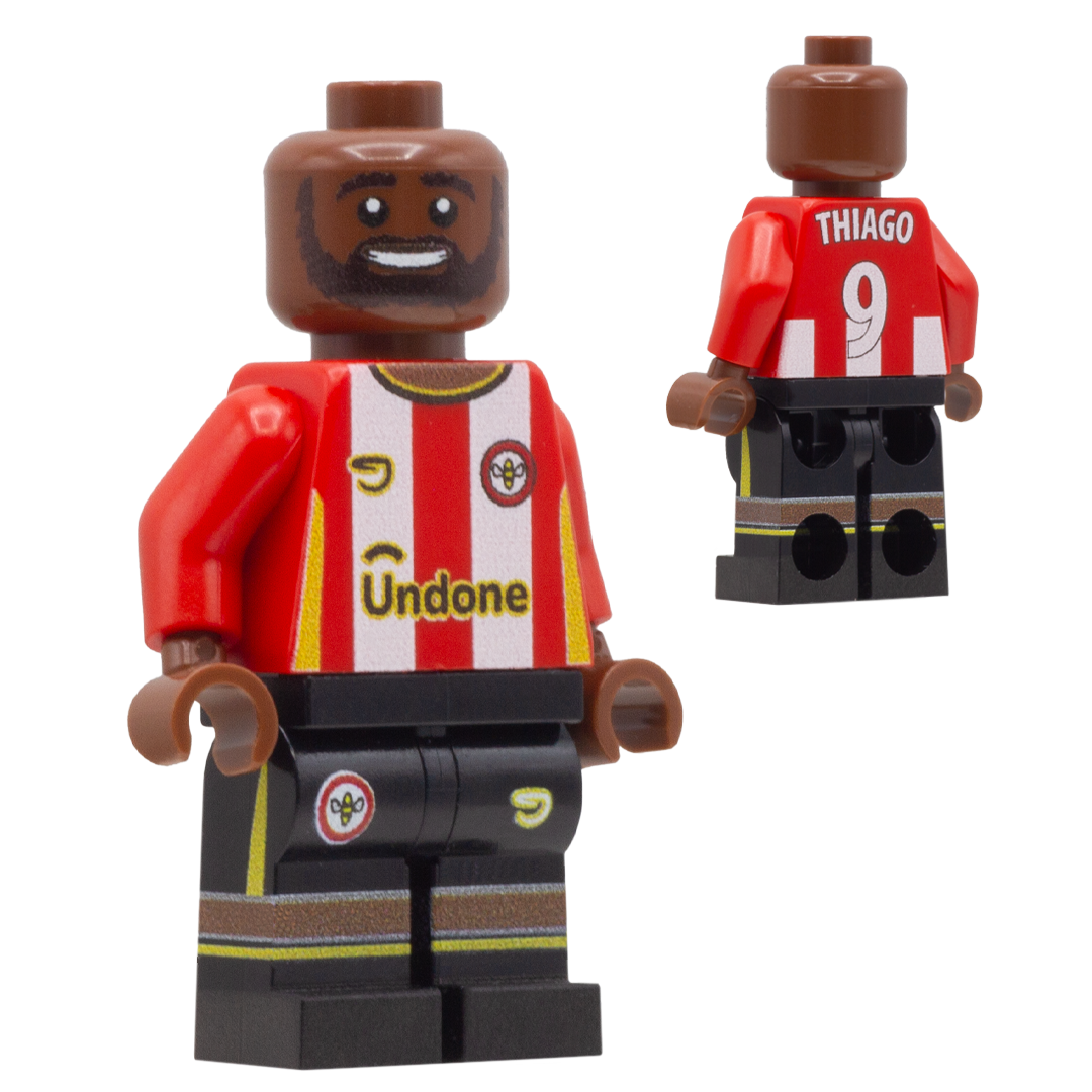 A custom-built toy minifigure of Brentford FC footballer Thiago. The figure is wearing a red and white striped jersey with 'Thiago' and the number '9' on the back, and 'Undone' on the front, paired with black shorts.