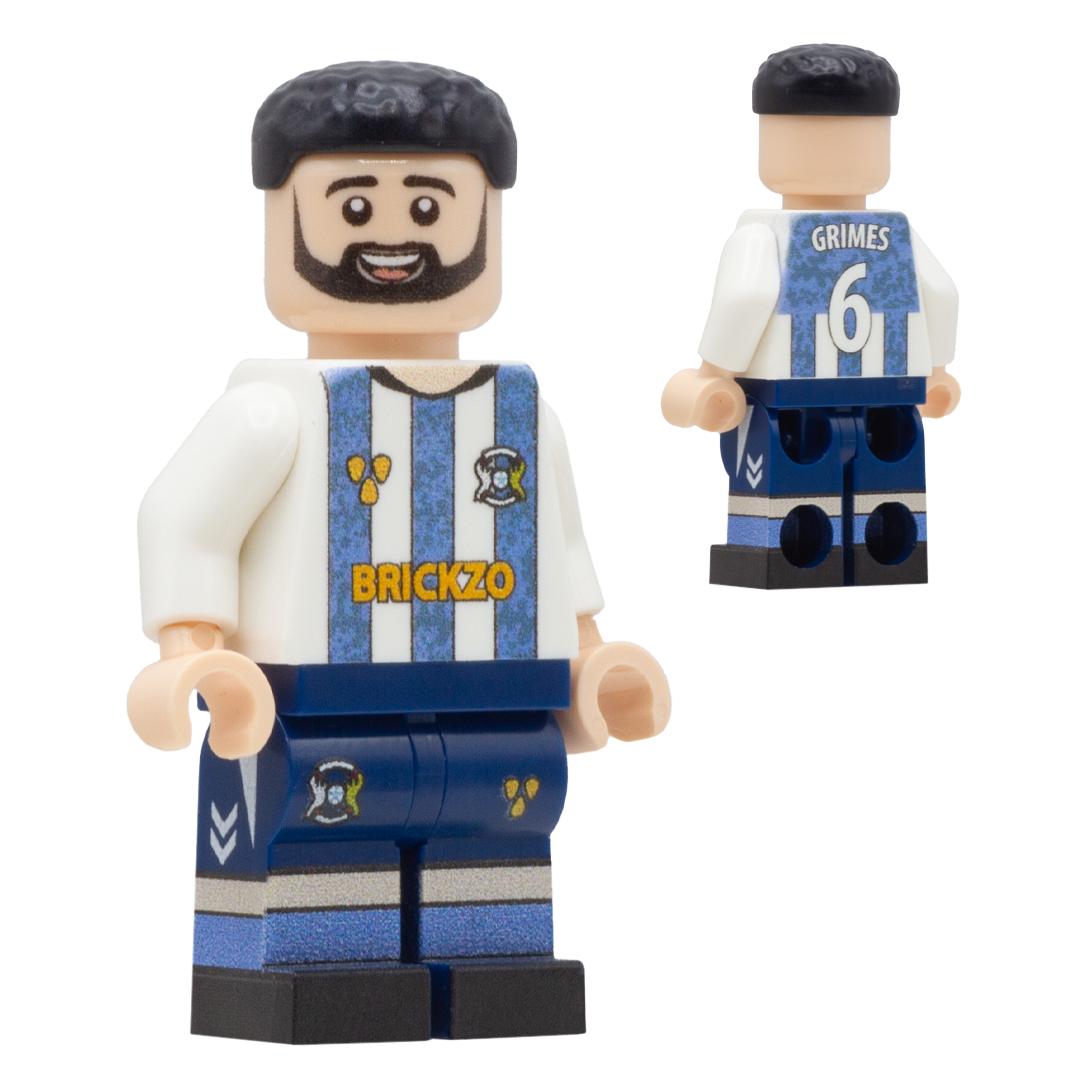 A custom LEGO-style soccer minifigure of Coventry City footballer Matt Grimes. The figure has a black beard and hair, wearing a white and blue striped jersey with 'BRICKZO' on the chest, a blue number 6 on the back, and blue shorts.