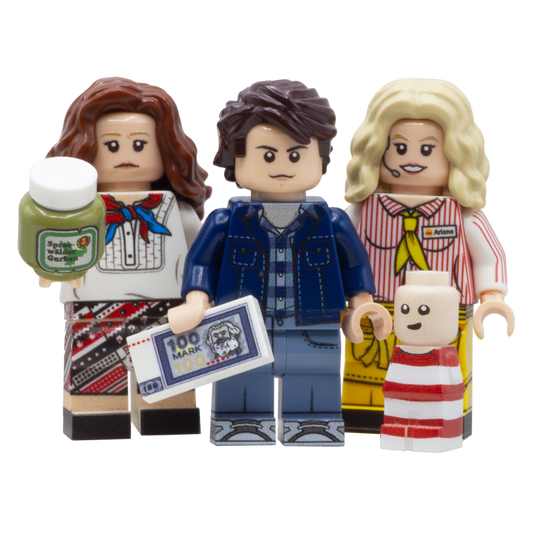 Three custom LEGO minifigures and a small baby figure, styled as characters from the film 'Good Bye Lenin' - mother holds a jar of pickles, Alex holds a 100 mark note and Ariane is dressed in her fastfood restaurant uniform.