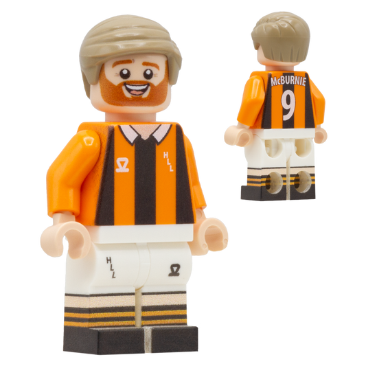 A custom Lego-style football minifigure of Hull City FC footballer Oli McBurnie. The figure wears a black and orange striped jersey, white shorts.