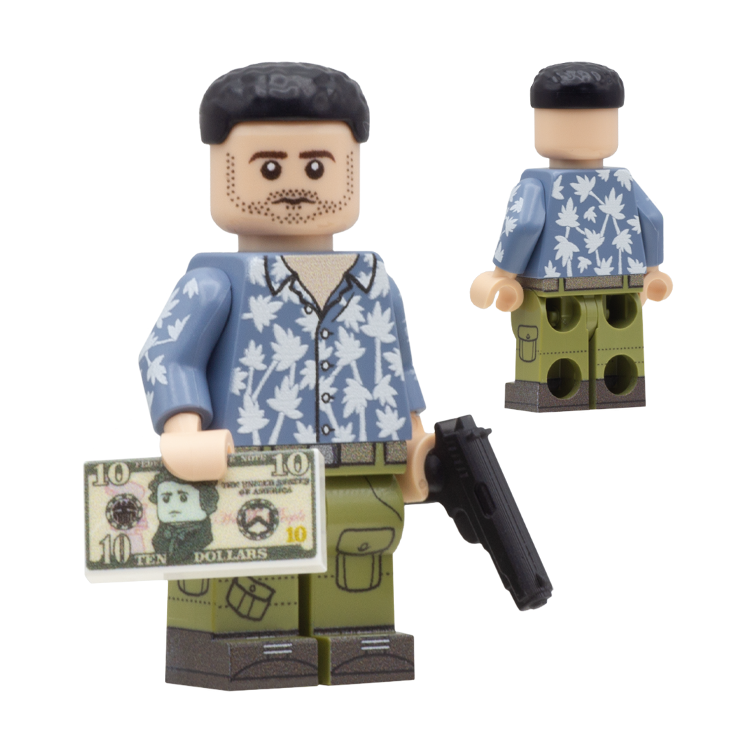 Custom Design LEGO Minifigure of Jason Duval from GTA 6  - The figure is a Caucasian male wearing a blue shirt with palm trees on it, he is also holding a pretend 3D printed gun accessory and a custom dollar bill tile. He has short cropped black har and light stubble.