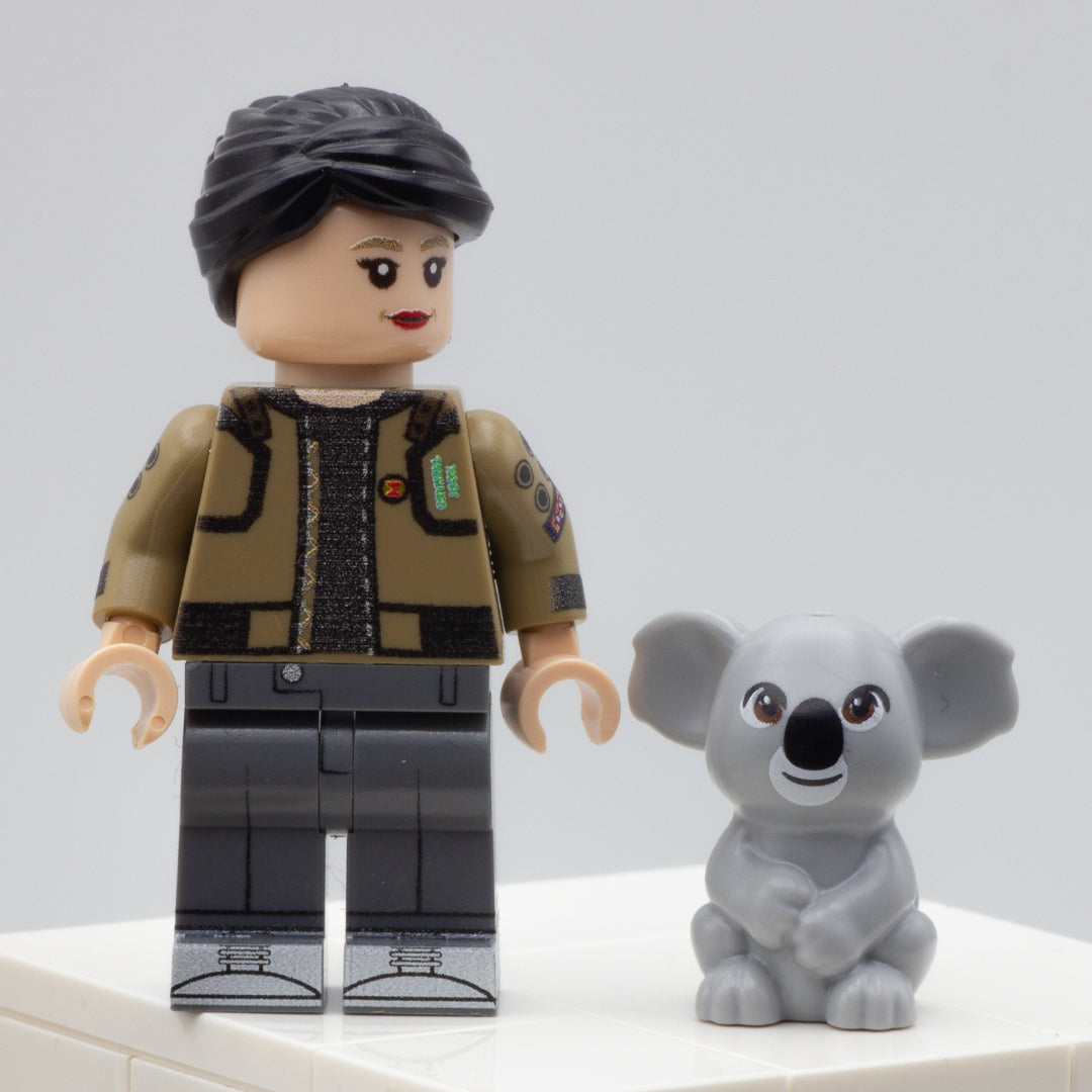 Minifigure standing next to cute grey LEGO koala with brown eyes and slight smile