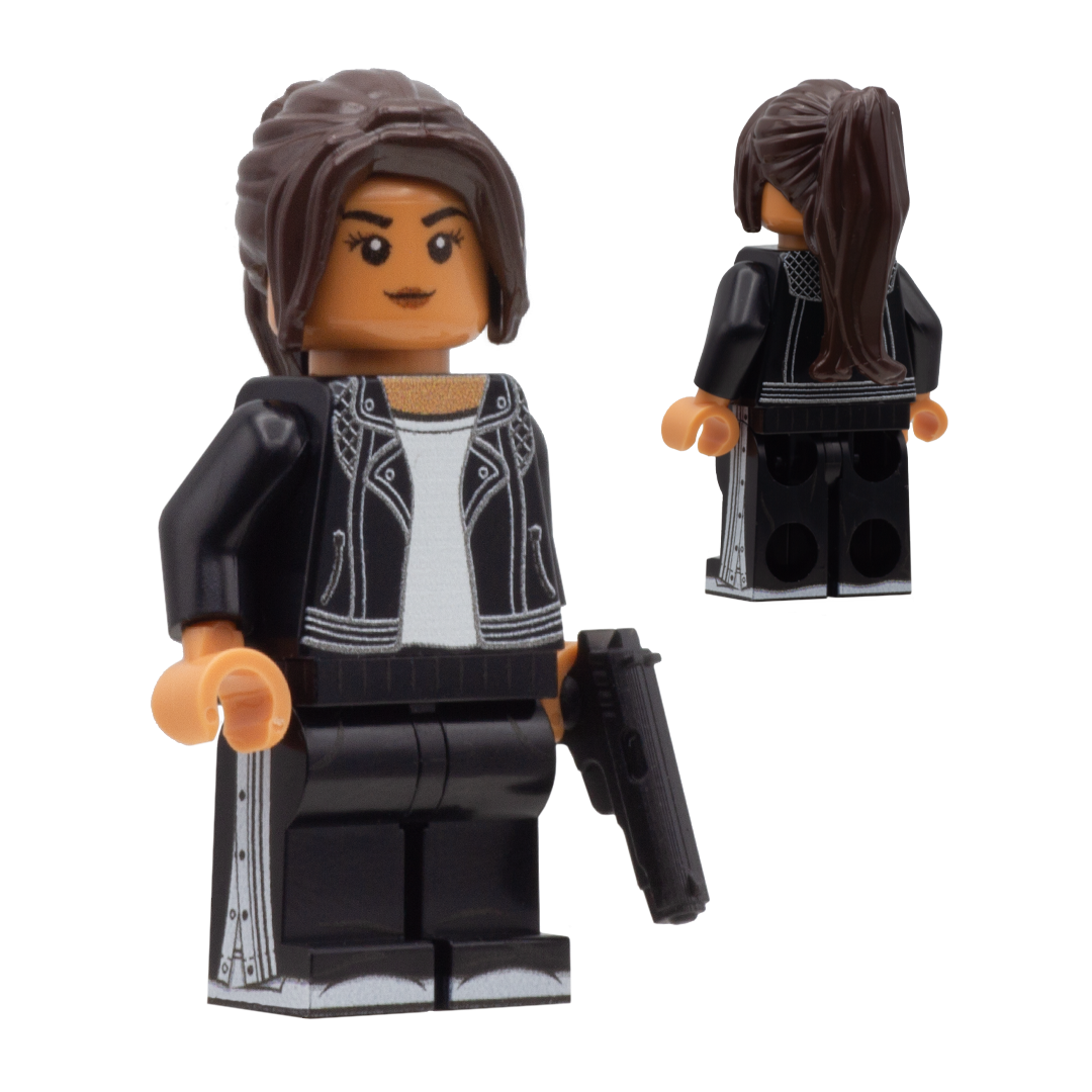 Custom Design LEGO Minifigure of Lucia Caminos from GTA 6  - The figure is a Hispanic female wearing a black leather jacket, she is holding a pretend 3D printed gun accessory. She has a long dark brown ponytail and black pants.