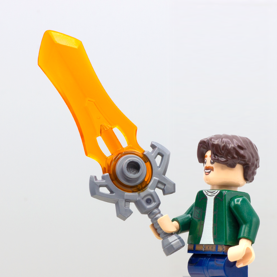LEGO minifigure holding large orange-bladed translucent fantasy sword with silver handle