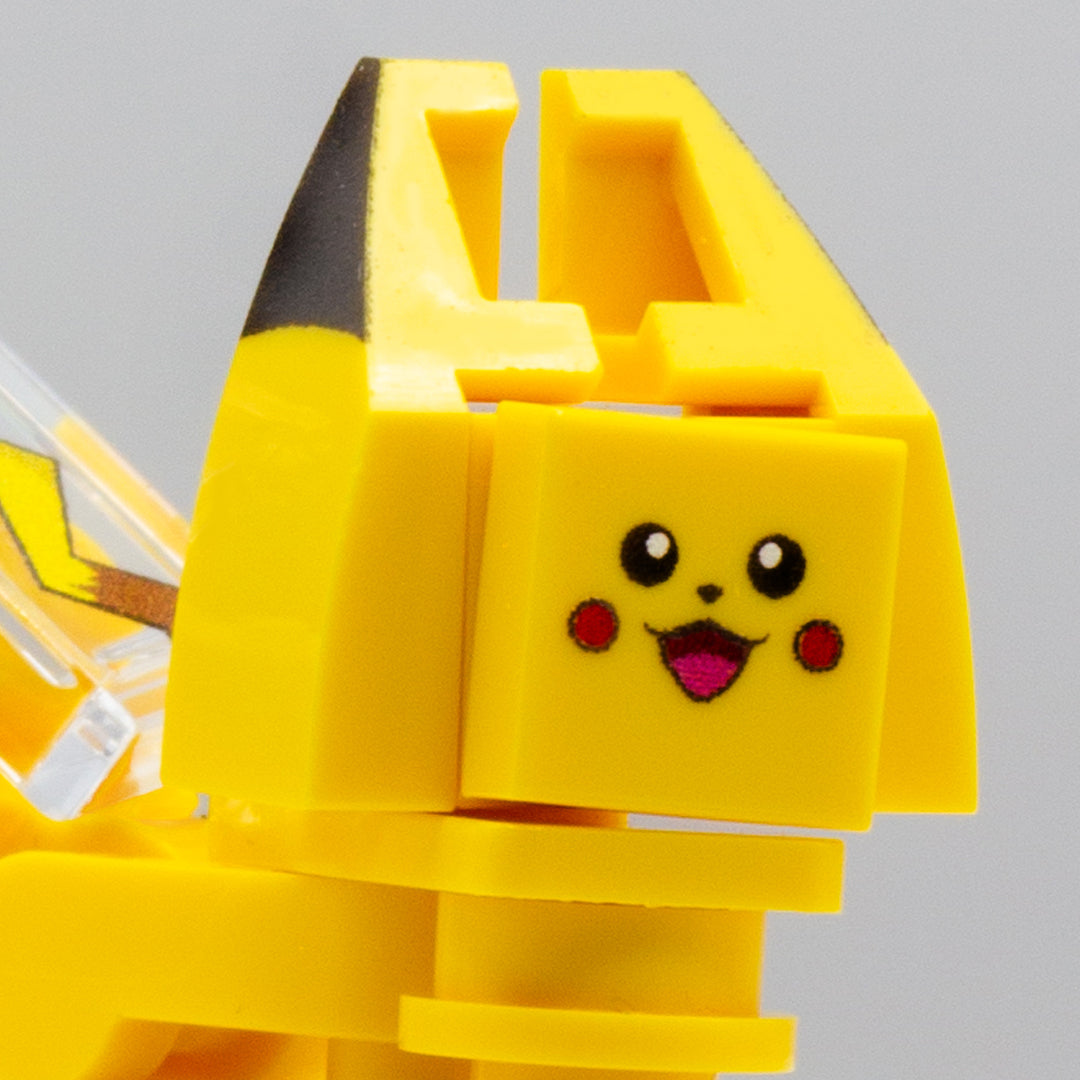 A close up to a cute face of a custom-printed LEGO minibuild inspired by Pikachu character, with ears, cute smiley face and eyes details visible. 