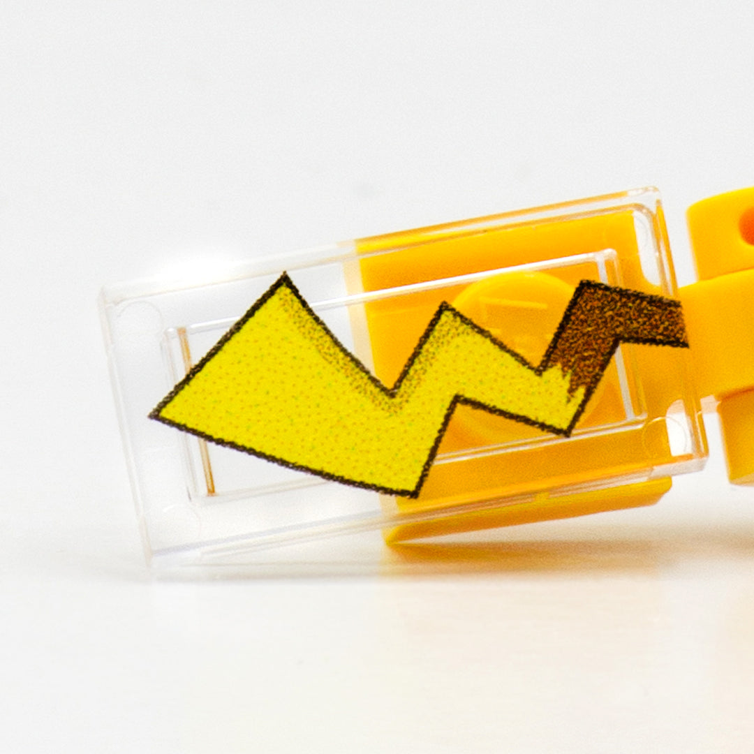 A close up to a tail of a custom-printed LEGO minibuild inspired by Pikachu character, with a quality, detailed print on a transparent LEGO  tile. 