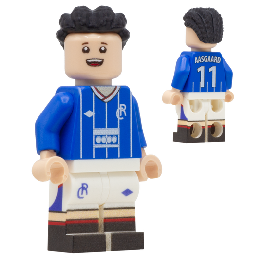 A LEGO-style soccer minifigure of Rangers FC footballer, Thelo Aasgaard. The figure wears a blue jersey with white striping, white shorts, and black hair.