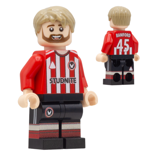 A LEGO-style football minifigure of Sheffield United footballer, Patrick Bamford. The figure has blond hair and a beard, wearing a red and white striped jersey with 'BAMFORD 45' and a circular crest, plus black shorts with red and white striping.