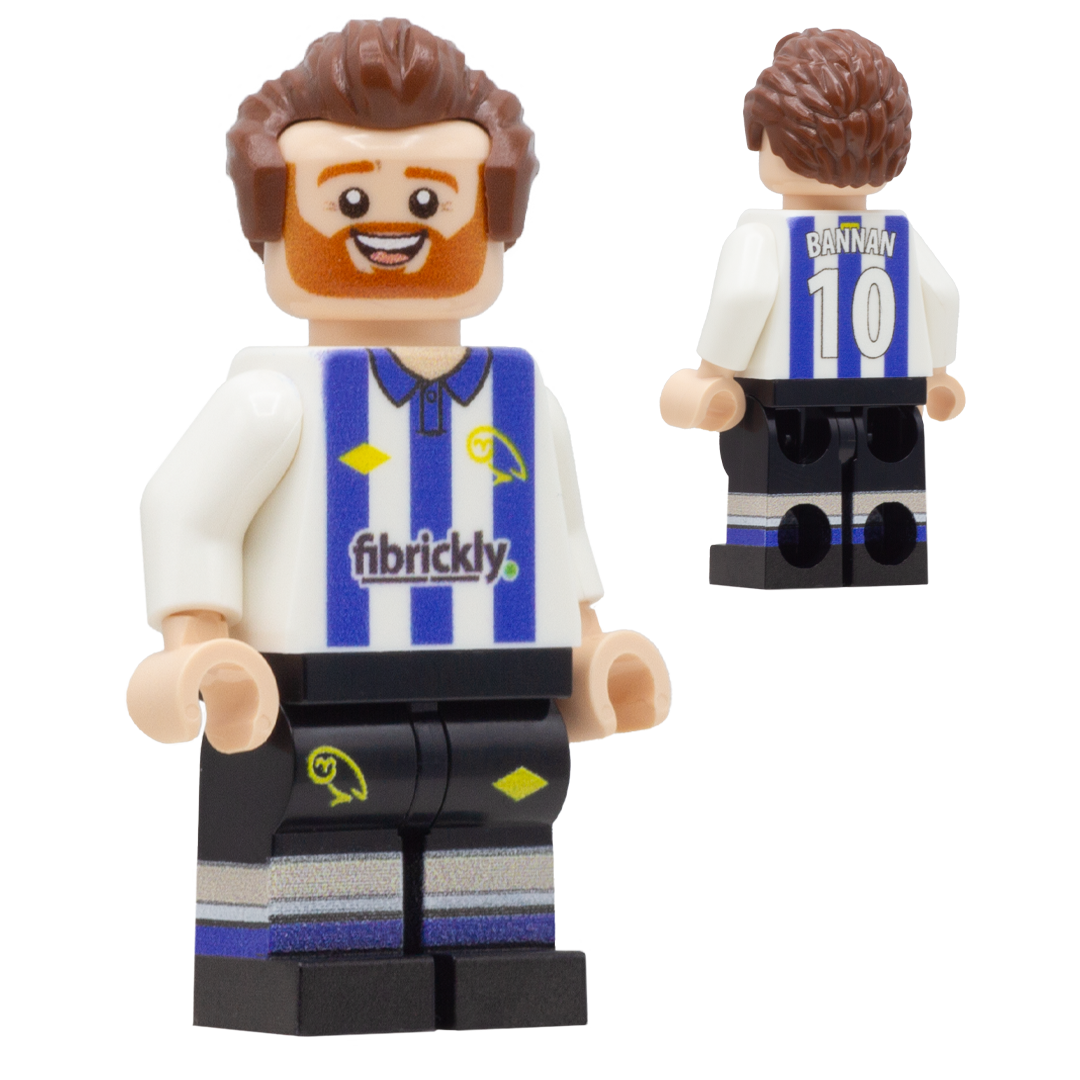 A custom LEGO-style football player minifigure of Sheffield Wednesday player, Barry Bannan. The figure has brown hair, a red beard, and is wearing a white and blue striped jersey with 'BANNAN 10' on the back, and black shorts with blue and white stripes.