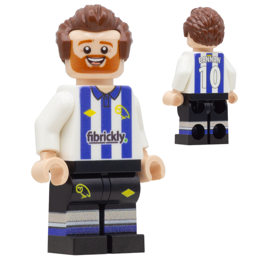 A custom LEGO-style football player minifigure of Sheffield Wednesday player, Barry Bannan. The figure has brown hair, a red beard, and is wearing a white and blue striped jersey with 'BANNAN 10' on the back, and black shorts with blue and white stripes.