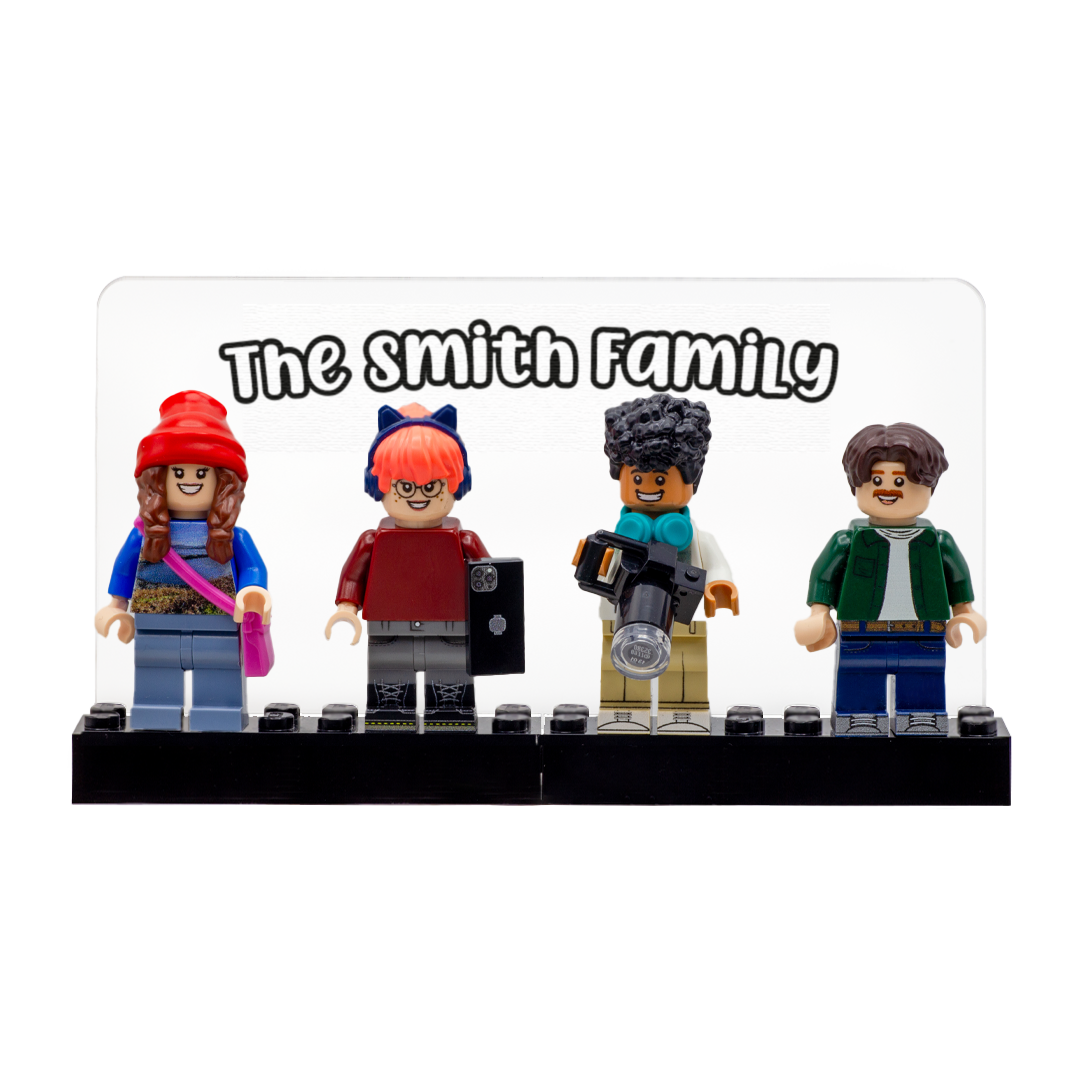 A custom LEGO-style family display featuring four minifigures standing on a black LEGO brick base with a clear acrylic sign above them that reads 'The Smith Family'.