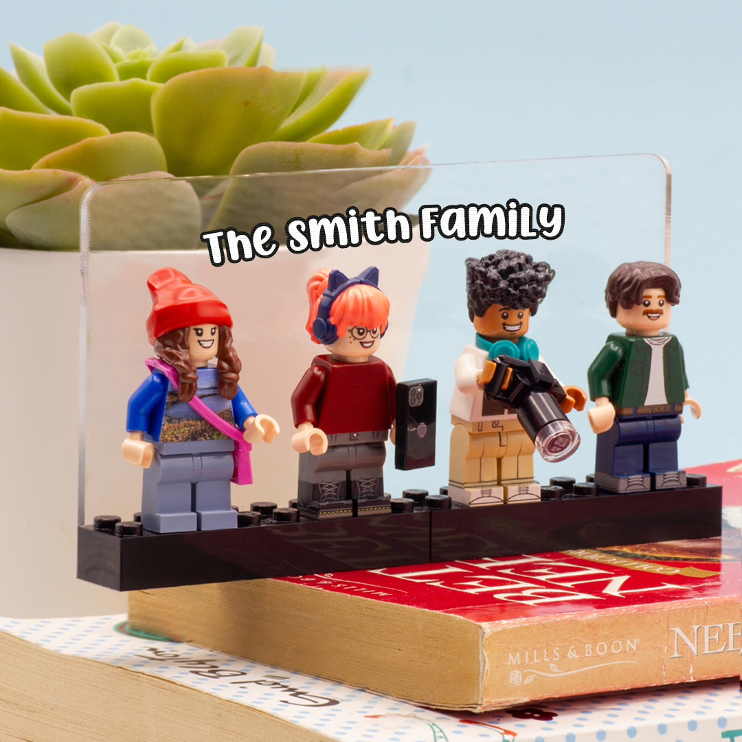 Set of four LEGO figures on a book with a plant in the background, and a personalised transparent display saying 'The Smith Family'