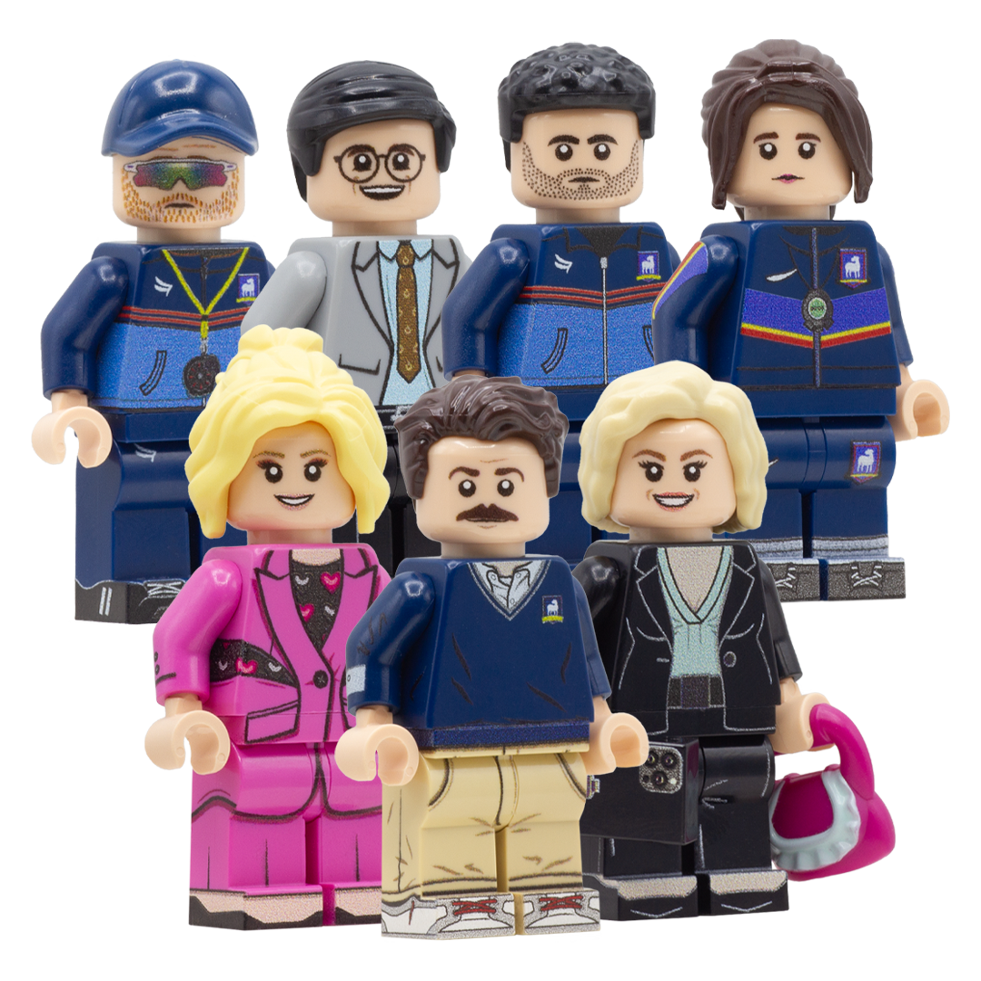 A set of seven custom-built toy LEGO minifigures resembling characters from Ted Lasso, arranged against a plain white background.