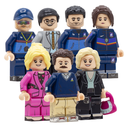 A set of seven custom-built toy LEGO minifigures resembling characters from Ted Lasso, arranged against a plain white background.