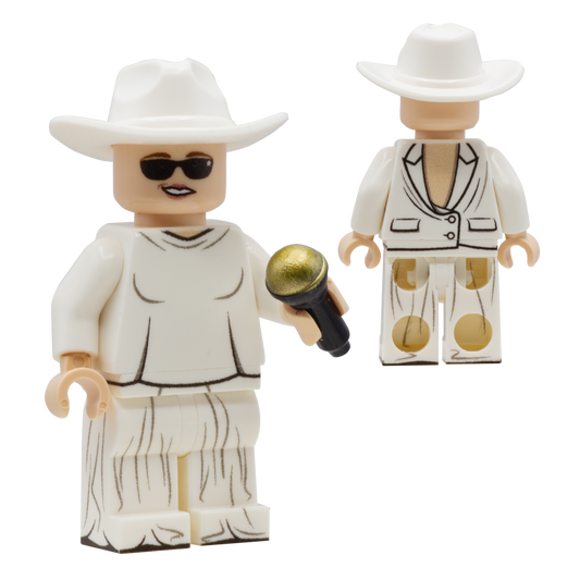 A custom LEGO minifigure of Celine Dion, wearing her iconic bcakwards white suit, a white cowboy hat and dark sunglasses
