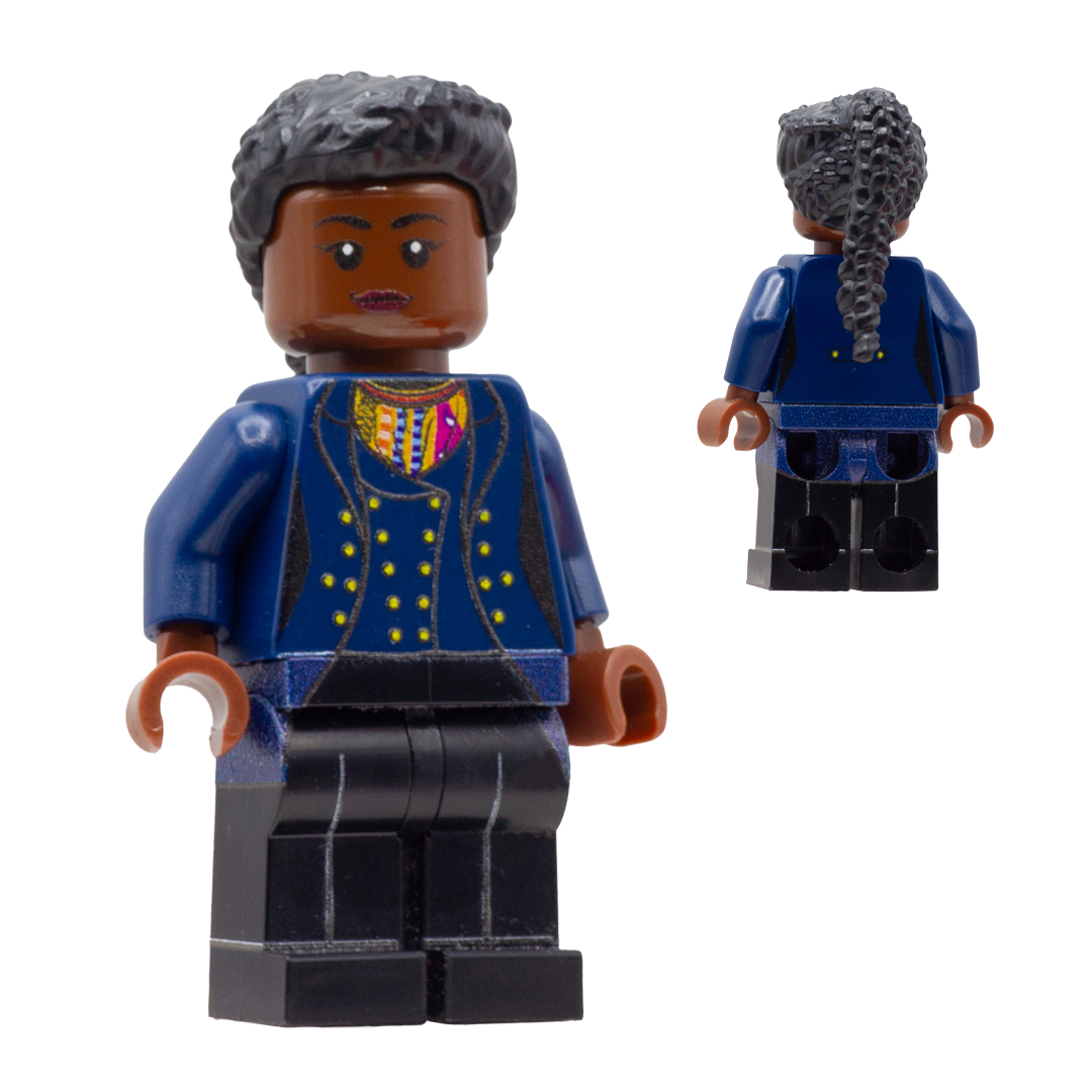 A custom LEGO minifigure of the Fugitive Doctor is shown from the front and back. The figure has dark brown skin, long black braided hair, a blue jacket with gold buttons and a multicolor patterned inner shirt, and black trousers.