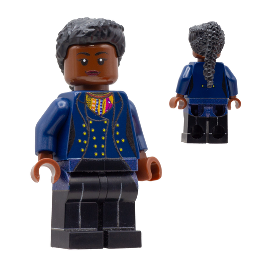 A custom LEGO minifigure of the Fugitive Doctor is shown from the front and back. The figure has dark brown skin, long black braided hair, a blue jacket with gold buttons and a multicolor patterned inner shirt, and black trousers.