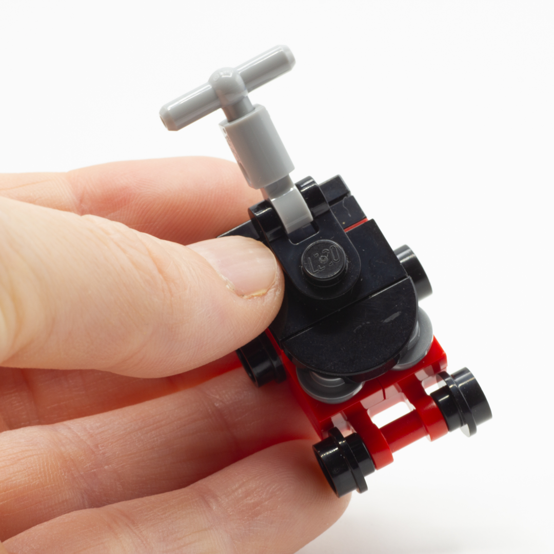 LEGO custom built lawnmower for your minifigure held in someone's hand