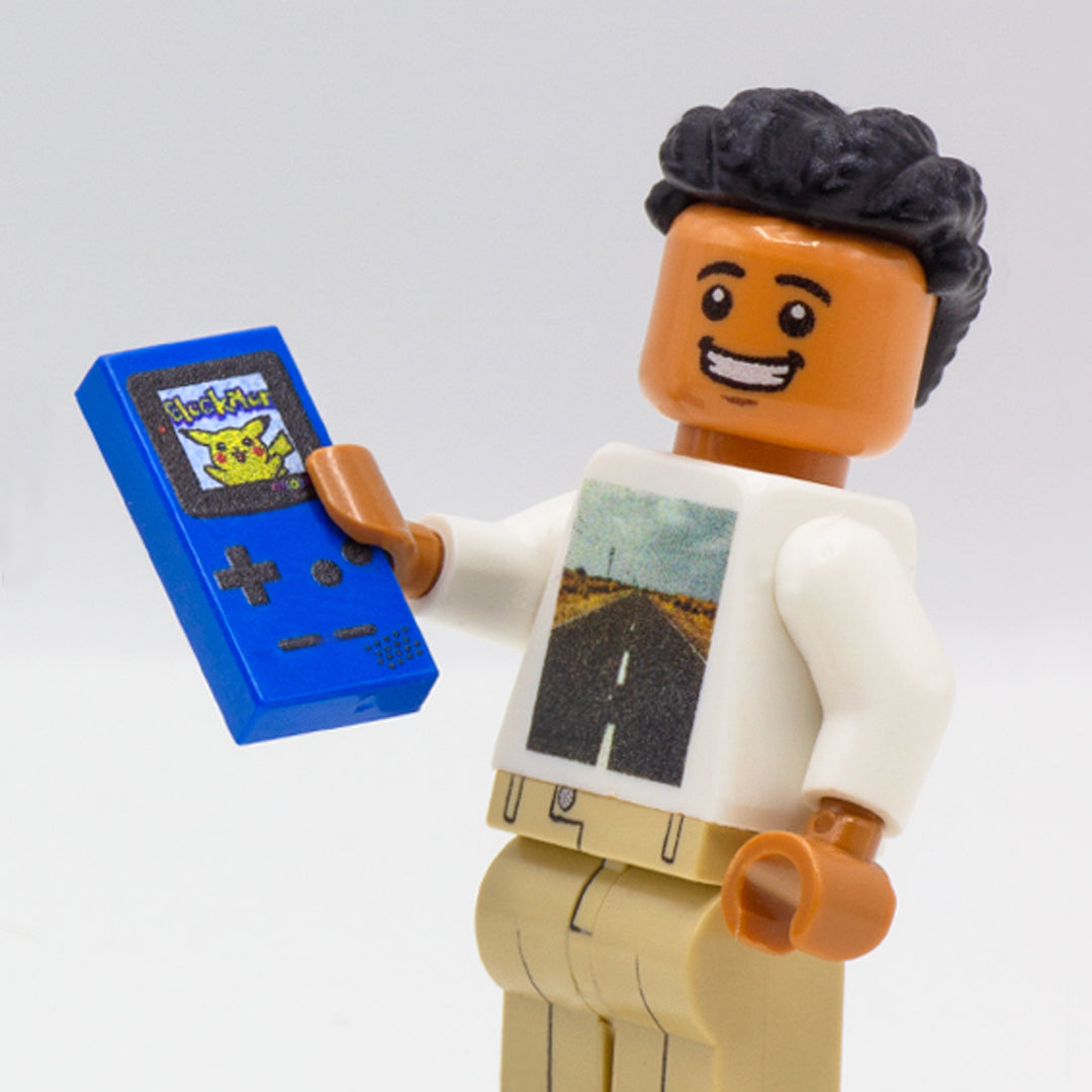 Custom LEGO minifigure holding a blue Nintendo Game Boy console printed on a LEGO tile