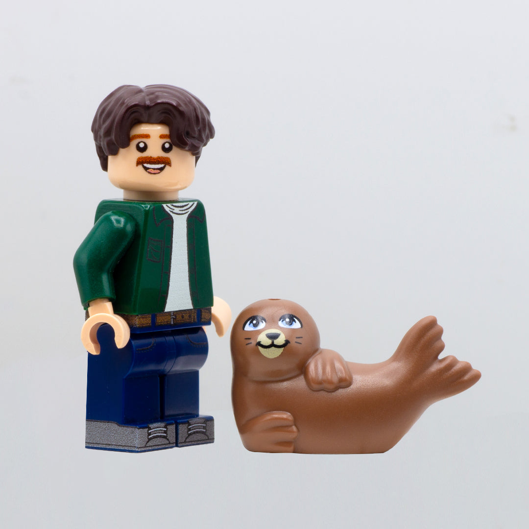 Brown LEGO seal laid on its side next to LEGO minifigure.