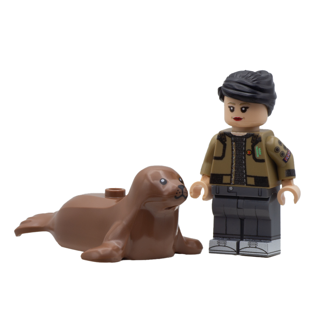 Minifigure standing next to a large LEGO brown seal minifigure accessory