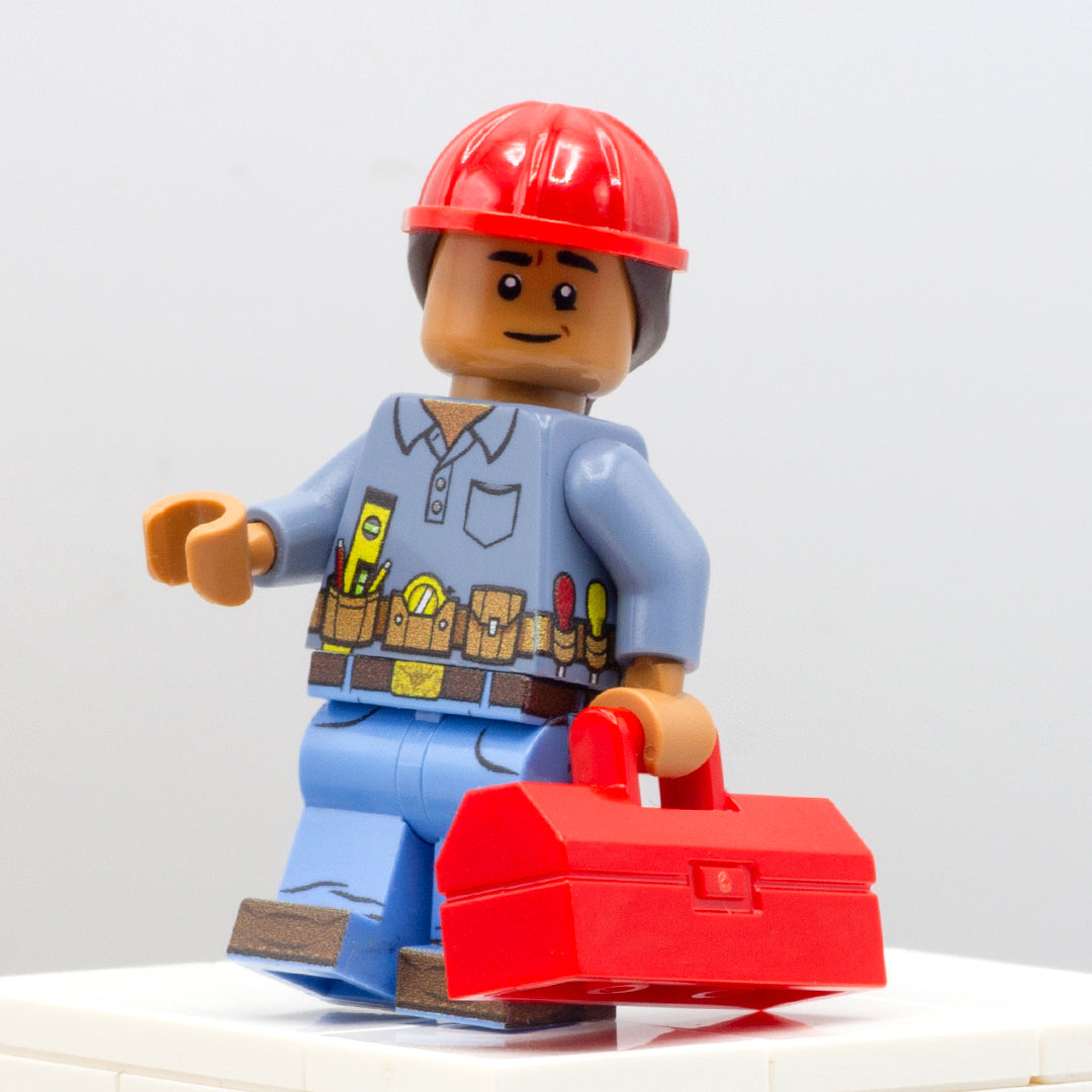 Construction worker wearing hard hat and handyman belt with tools, carrying red LEGO minifigure toolbox.