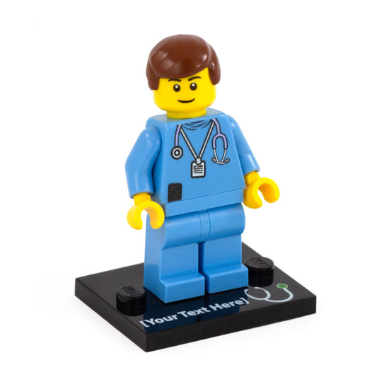 A custom lego minifigure in a light blue nursing uniform with short brown hair, closed smile and a black custom text baseplate with a printed stethoscope symbol