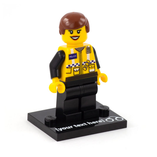 a custom lego minifigure dressed as a uk police officer with short hair, smile and eyelashes, stood on a custom text baseplate with a printed handcuffs symbol